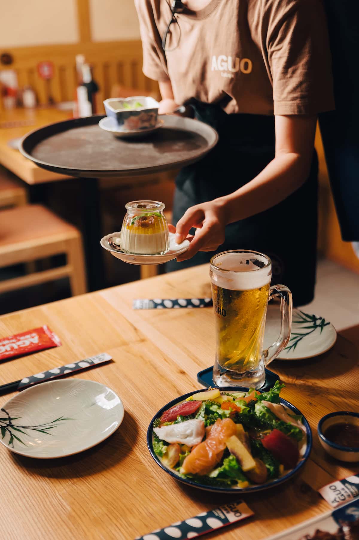 Aguo Izakaya table setting with a seafood salad and Sapporo.