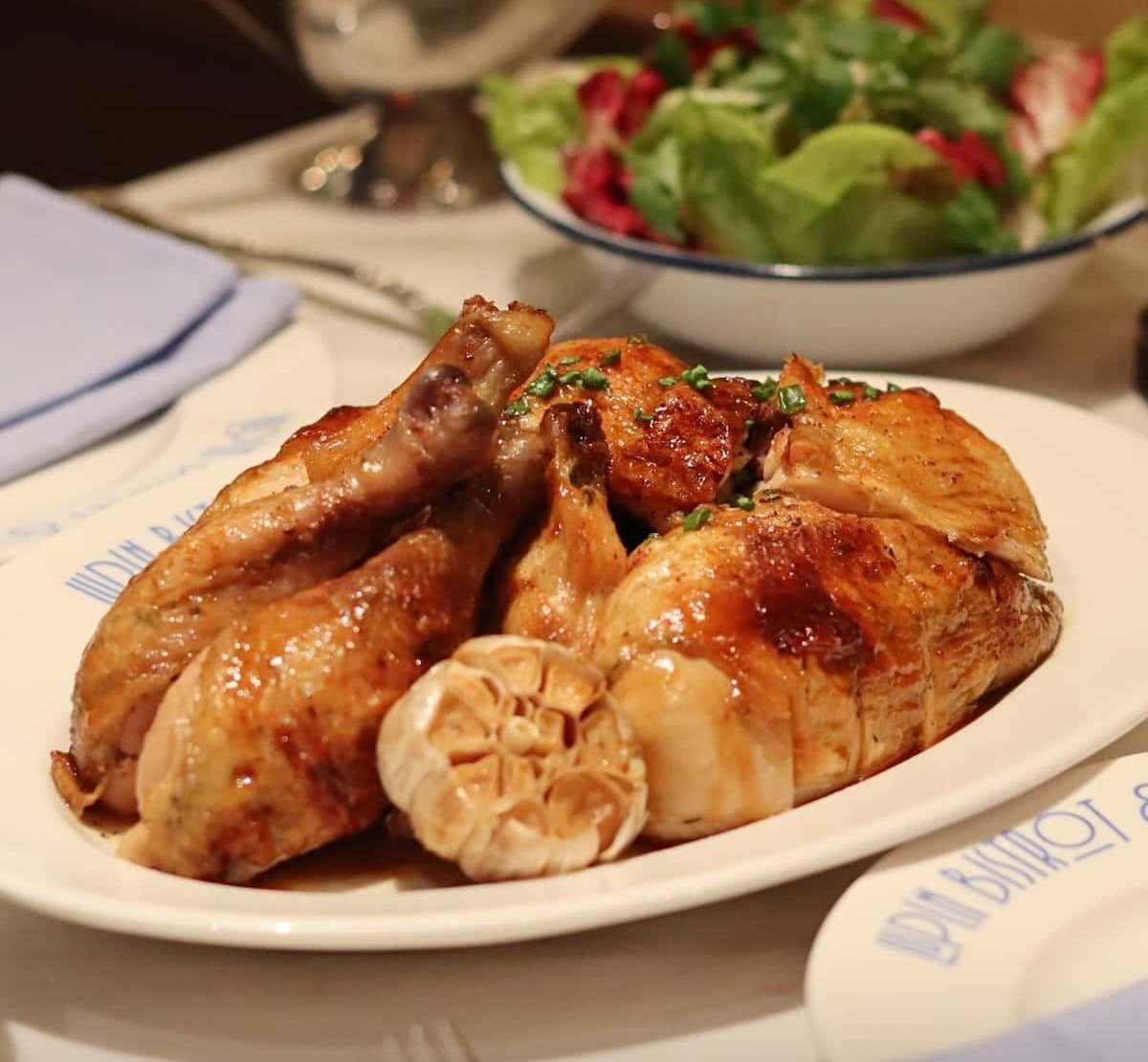 Grilled chicken and garlic on a plate.