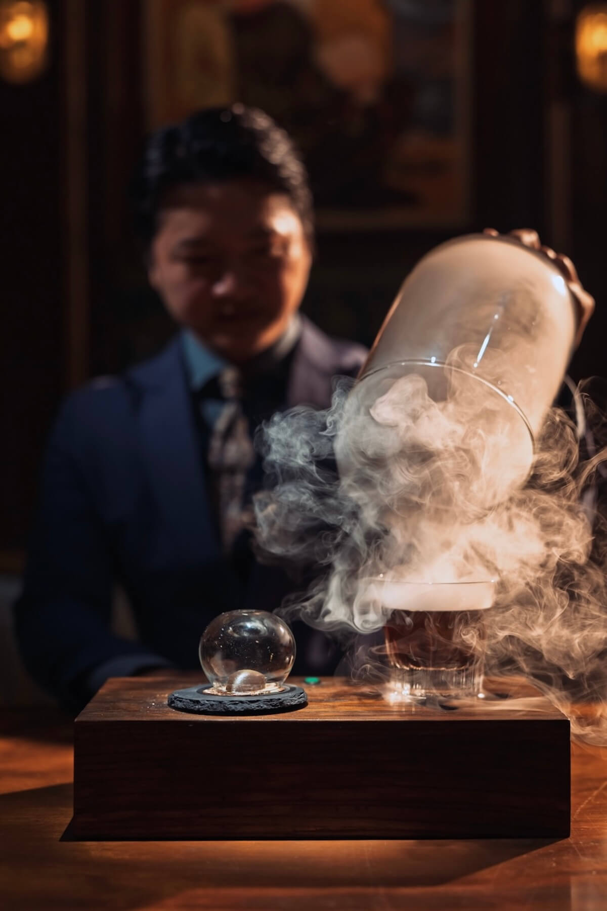 a man pouring liquid into a glass