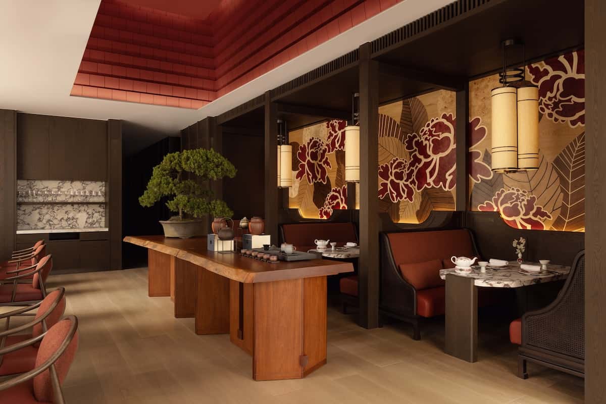 Chinese restaurant with a mural on the wall and wooden table.