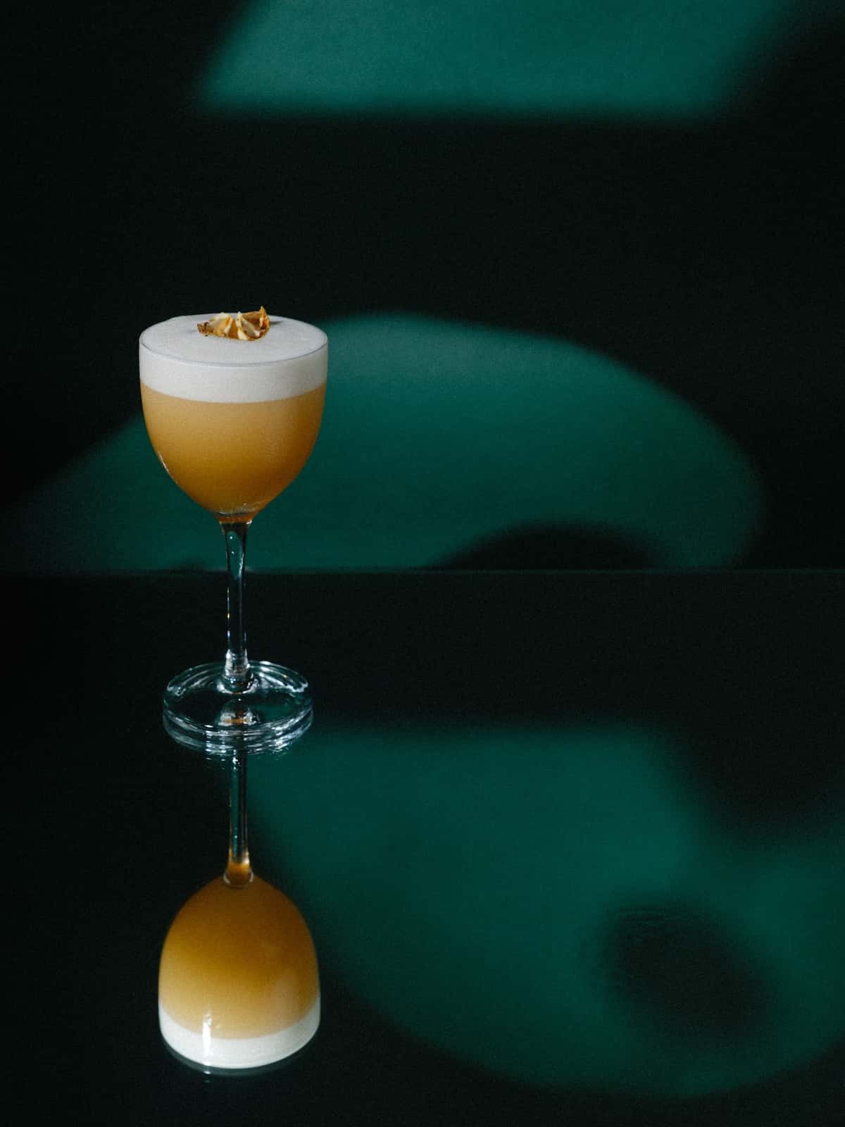 A cocktail with its reflection.