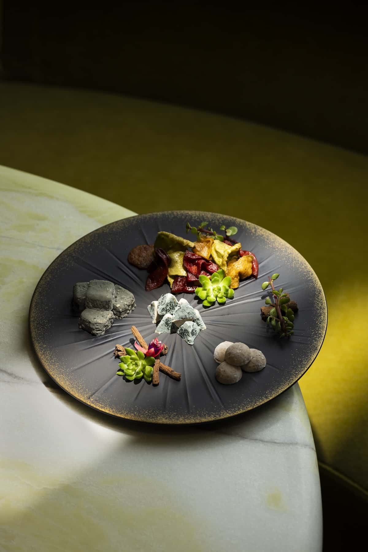 Food on a plate on the edge of a table.