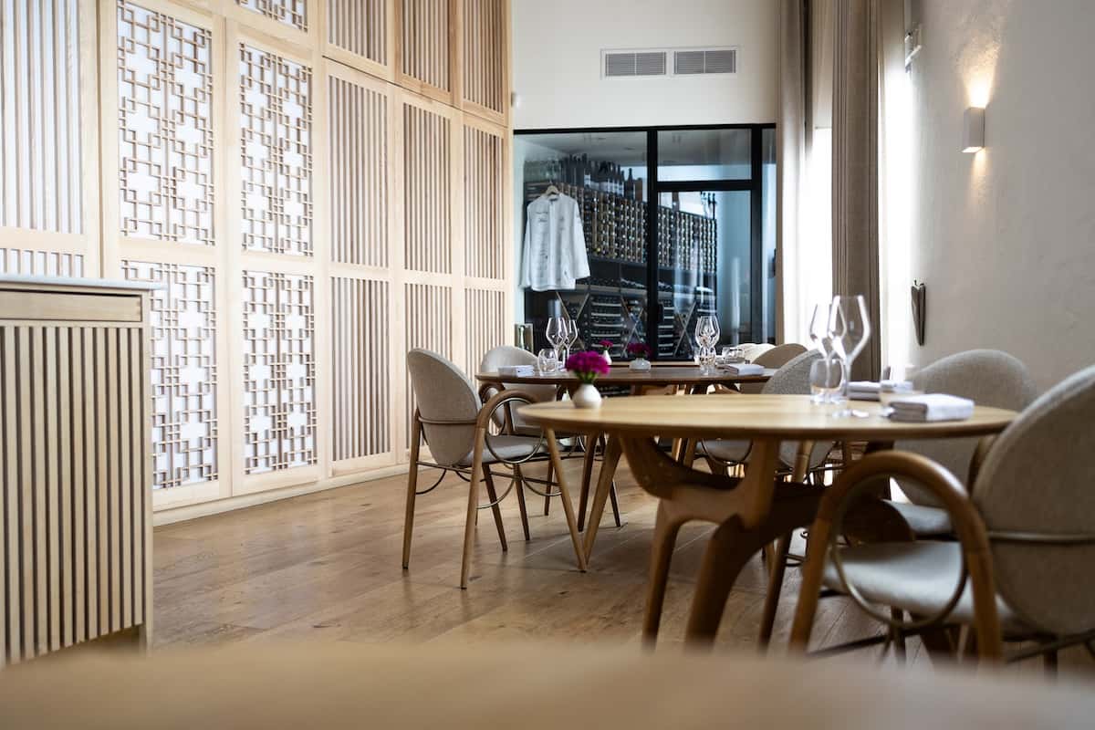 A table and light wooden walls. 