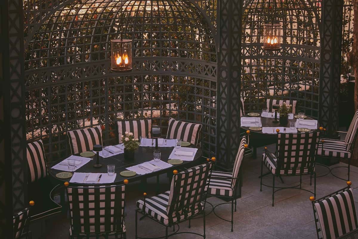 A terrace area with striped chairs. 