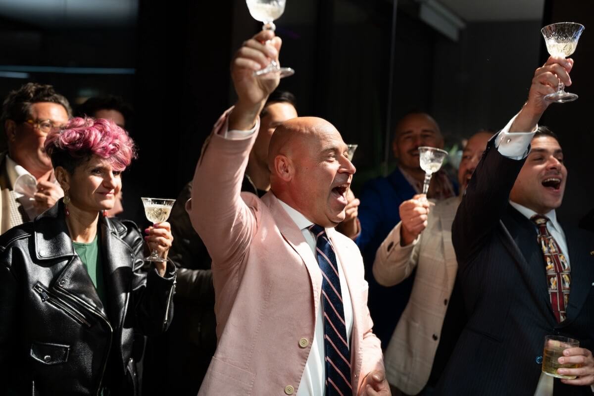 Some people raising glasses to cheers.