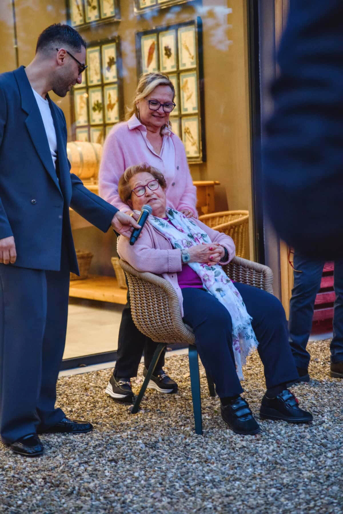 A woman in a chair speaking into a mic.
