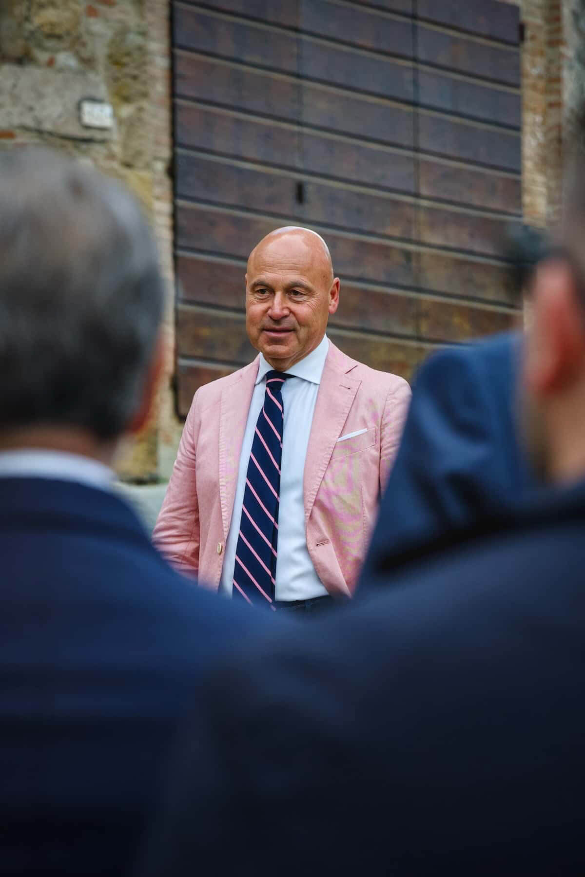 A man in a pink blazer and tie.
