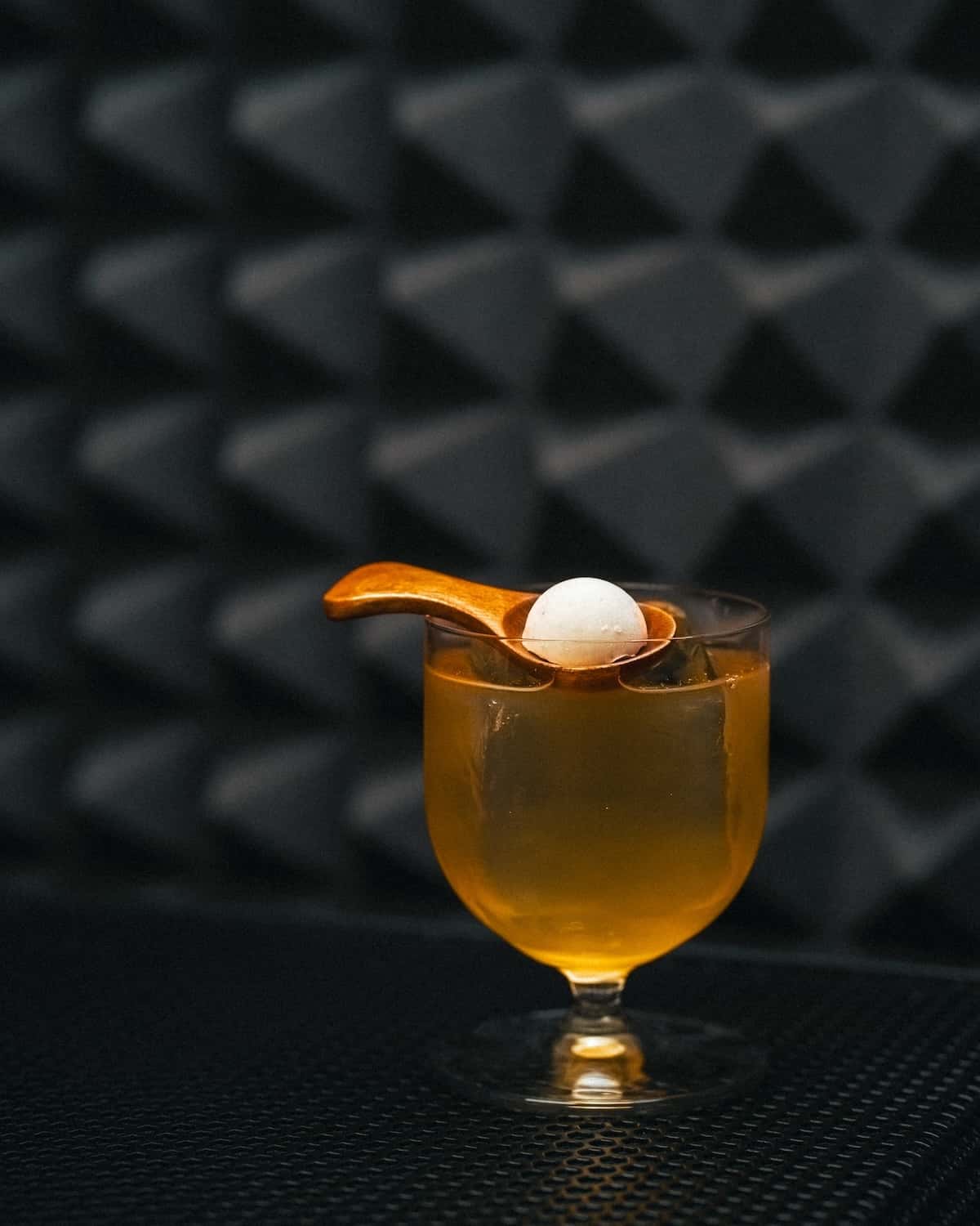 a glass with a ball in it